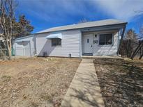 Charming single-story home featuring light siding, blue trim, and a well-maintained front yard at 970 Lima St, Aurora, CO 80010