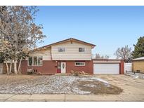 Charming two-story home featuring brick accents and an attached two car garage, offering both curb appeal and practicality at 6374 Upham St, Arvada, CO 80003