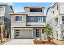 Contemporary two-story home with a two-car garage and modern architectural details and landscaping at 8213 Butte Creek St, Littleton, CO 80125
