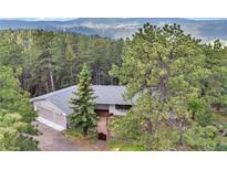 Secluded home exterior nestled in the woods with mountain views at 900 Ballantine Rd, Golden, CO 80401