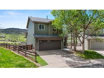 Charming two-story home with a spacious two-car garage, fenced yard, and beautiful landscaping at 9721 Marmot Ridge Cir, Littleton, CO 80125