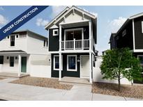 Charming two-story home boasting black siding, white trim, and a cozy second-floor balcony at 13151 E 103Rd Pl, Commerce City, CO 80022