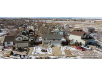 Charming two-story home with a well-maintained lawn, complemented by picturesque mountain views in the background at 1109 Ash Ct, Fort Lupton, CO 80621