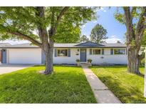 Charming single-story home featuring well-maintained lawn and lush trees in a serene, residential neighborhood at 6635 S Sherman St, Centennial, CO 80121