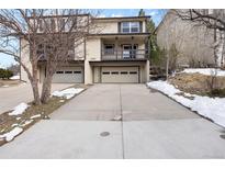 Two-story townhome with attached garage and driveway, offering convenient parking and curb appeal at 395 Raspberry Ln, Monument, CO 80132