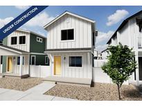 Two-story craftsman style home with a yellow door, white siding, and a small front yard at 10317 E Vaughn Ave, Commerce City, CO 80022