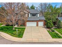 Charming two-story brick home with a well-manicured lawn and a two-car garage at 5305 W Lake Pl, Littleton, CO 80123