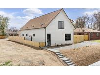 Charming home featuring white siding, a brown roof, black trim windows, and a light wood fence at 3890 N Cook St, Denver, CO 80205