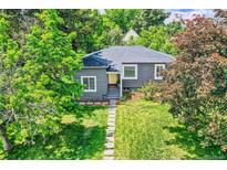 Charming single-story home with lush, mature trees and manicured lawn at 1901 S Adams St, Denver, CO 80210