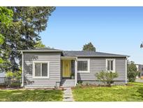 Charming single-story home featuring a well-manicured lawn and a welcoming yellow front door at 1901 S Adams St, Denver, CO 80210