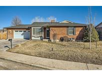 Charming red brick home with a well-maintained front yard and attached garage at 438 N 11Th Ave, Brighton, CO 80601