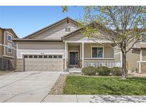 Charming single-Gathering home with a well-manicured lawn and covered front porch at 9751 Mobile St, Commerce City, CO 80022