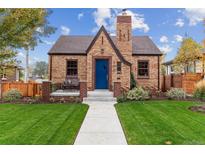 Charming brick home with a well-manicured lawn and a welcoming blue front door at 4710 W 32Nd Ave, Denver, CO 80212