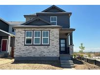 Charming two-story home features a stone facade, dark accents, and a modern front door at 23762 E 33Rd Pl, Aurora, CO 80019