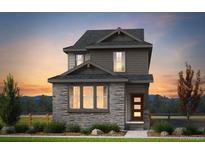 Two-story home with stone and siding exterior, complemented by manicured landscaping at 23762 E 33Rd Pl, Aurora, CO 80019