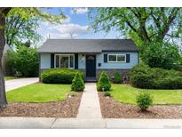 Charming home featuring a well-manicured front yard with lush landscaping and inviting curb appeal at 765 Iola St, Aurora, CO 80010