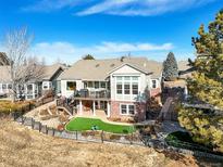 Beautiful backyard featuring a deck, patio, and landscaped garden in a well-maintained property at 3101 Rockbridge Dr, Highlands Ranch, CO 80129