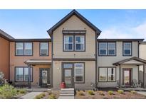 Charming townhome featuring neutral siding, trim, and tidy front yard landscaping at 11440 E Martin Luther King Jr Blvd, Denver, CO 80238