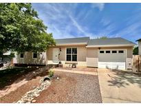 Charming single-story home featuring a well-maintained lawn, neutral toned exterior, and attached one car garage at 9346 Flower St, Broomfield, CO 80021