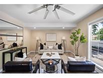 Bright living room with stylish furniture, ceiling fan, and view from large window at 9346 Flower St, Broomfield, CO 80021