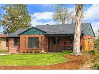 Charming brick home with well-manicured lawn and inviting curb appeal at 2120 N Poplar St, Denver, CO 80207
