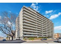 A multi-story building with a classic design featuring symmetrical balconies, offering city views at 909 N Logan St # 6J, Denver, CO 80203