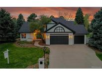 Charming home with a three-car garage, well manicured lawn, professional landscaping and an inviting walkway at 44 Spyglass Dr, Littleton, CO 80123