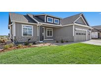 Charming gray single-Gathering home features a well-manicured lawn and stone accents at 1369 Burt Ave, Berthoud, CO 80513