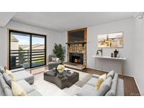 Cozy living room with a stone fireplace and a sliding door to a balcony with plenty of natural light at 7665 E Eastman Ave # D304, Denver, CO 80231