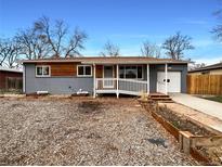 Charming ranch-style home featuring a gray exterior, ramp, and tidy landscaping at 6757 Lee St, Arvada, CO 80004