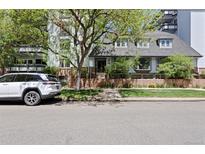 Inviting home exterior featuring well-maintained landscaping and a charming brick wall at 555 E 10Th Ave # 15, Denver, CO 80203