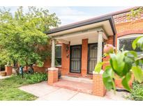 Charming brick duplex entrance with covered porch and well-maintained landscaping at 3071 W 38Th Ave, Denver, CO 80211