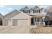 Inviting two-story home with a three car garage, and landscaped front yard at 13033 Birch Dr, Thornton, CO 80241