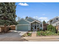 Charming one-story home with a well-maintained front yard and an attached two-car garage at 10624 W Berry Pl, Littleton, CO 80127