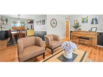 Inviting living room featuring cozy seating, piano, and pet-themed decor for a warm, personal touch at 5485 S Lakeview St, Littleton, CO 80120