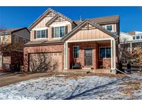 Two-story brick home with attached garage and landscaping at 6842 S Algonquian Ct, Aurora, CO 80016
