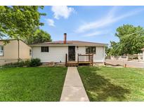 Charming home with a well-maintained lawn and welcoming front porch at 4505 W Gill Pl, Denver, CO 80219