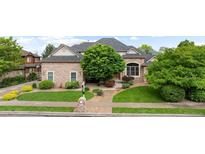 Charming stone-clad home with a lush front yard, mature trees, and well-manicured landscaping at 1313 Jade Ln, Longmont, CO 80504