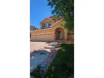 Charming two-story home boasts a three-car garage and inviting front porch at 2544 S Fundy Cir, Aurora, CO 80013