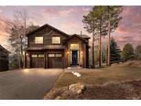 Charming two-story home featuring a two-car garage, lovely stone accents and a welcoming front entrance at 26176 Sweetbriar Trl, Evergreen, CO 80439