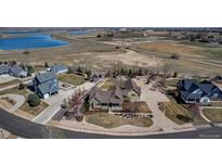 Expansive aerial view of a home featuring large lot, green lawn and an inviting neighborhood atmosphere at 3545 Cottonwood Cir, Longmont, CO 80504