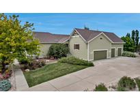 Charming home featuring a three car garage, well-manicured lawn, and beautiful landscaping at 3545 Cottonwood Cir, Longmont, CO 80504