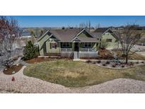 Charming two-story home with a welcoming front porch and well-manicured lawn at 3545 Cottonwood Cir, Longmont, CO 80504