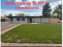 A lovely home featuring a large backyard with plenty of green space for outdoor activities and entertainment at 9950 W 17Th Ave, Lakewood, CO 80215