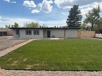 Stunning single-story home with well-manicured lawn and inviting entrance at 9950 W 17Th Ave, Lakewood, CO 80215