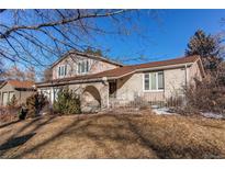 Two-story brick home with a brown roof and attached garage at 1834 S Oakland St, Aurora, CO 80012