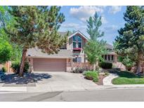 Charming two-story home with mature trees, brick accents, and a two-car garage at 5373 E Links Cir, Centennial, CO 80122