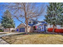Beautiful two story home with blue siding, stone accents, manicured lawn and mature trees at 19346 E Prentice Ln, Centennial, CO 80015