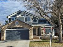 Charming two-story home with a stone-accented garage and inviting front porch at 19346 E Prentice Ln, Centennial, CO 80015
