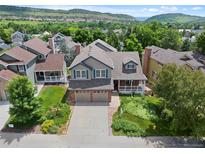 Beautiful two-story home featuring a well-manicured lawn, two-car garage and mountain views at 18 Blue Sage, Littleton, CO 80127
